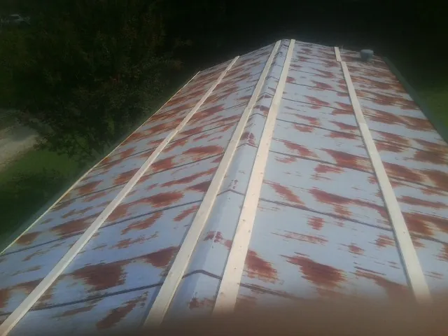 Rusted metal roof panels with new wood purlins before replacement — Storm Damage Roof Repair in Media by Roofing Brothers